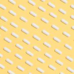 white capsules on yellow background