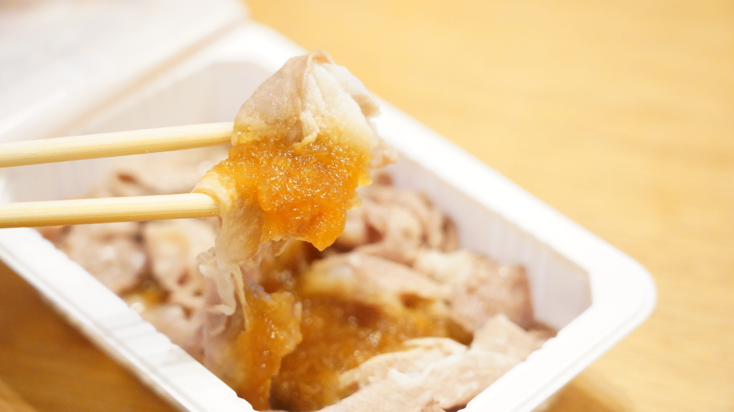 セブンイレブンのおすすめ冷凍食品「豚しゃぶおろしポン酢」を箸でつまんでいる写真