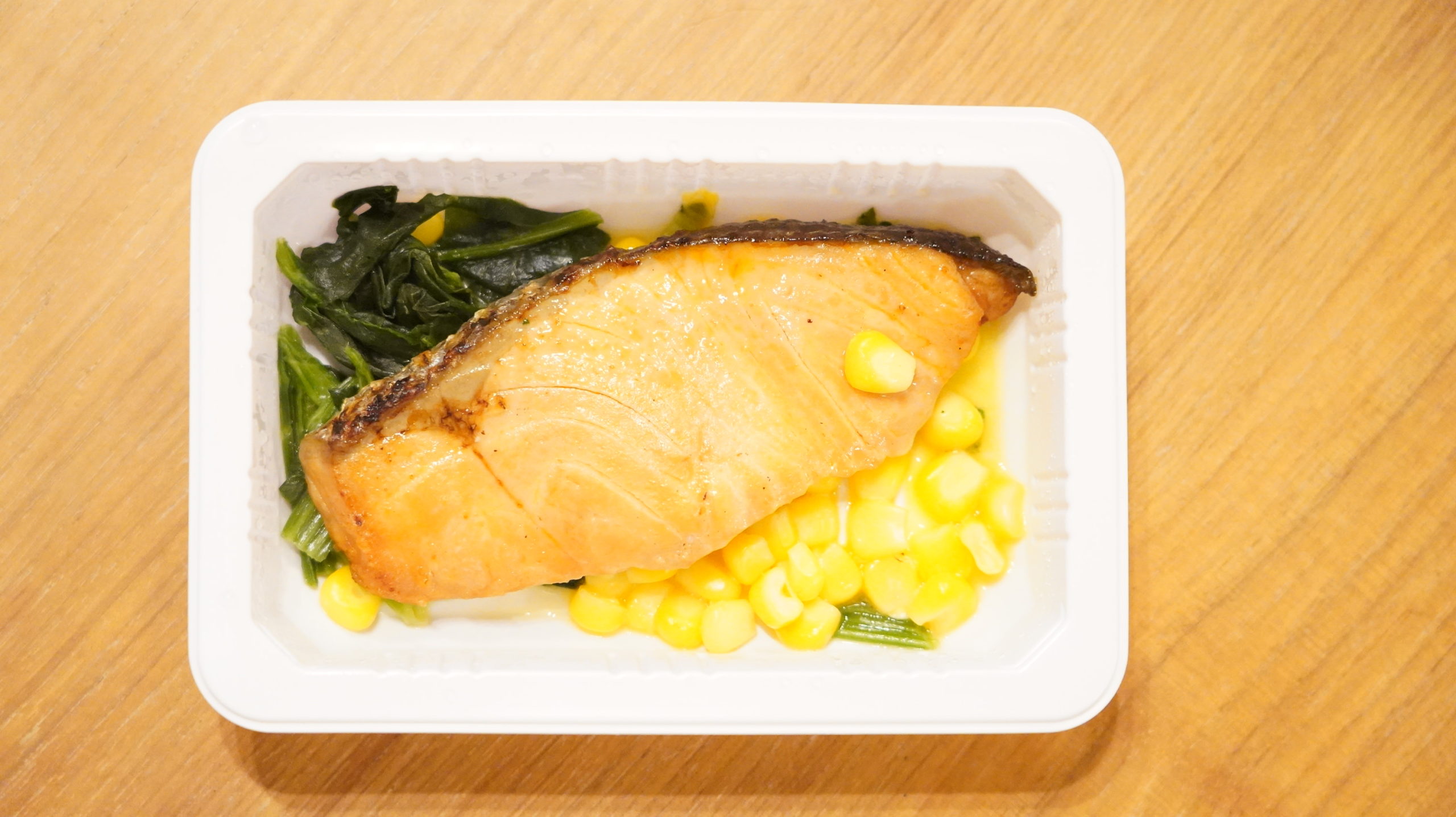 セブンイレブンの冷凍食品「バター香る銀鮭の醤油焼」の銀鮭、ほうれん草、コーンの写真