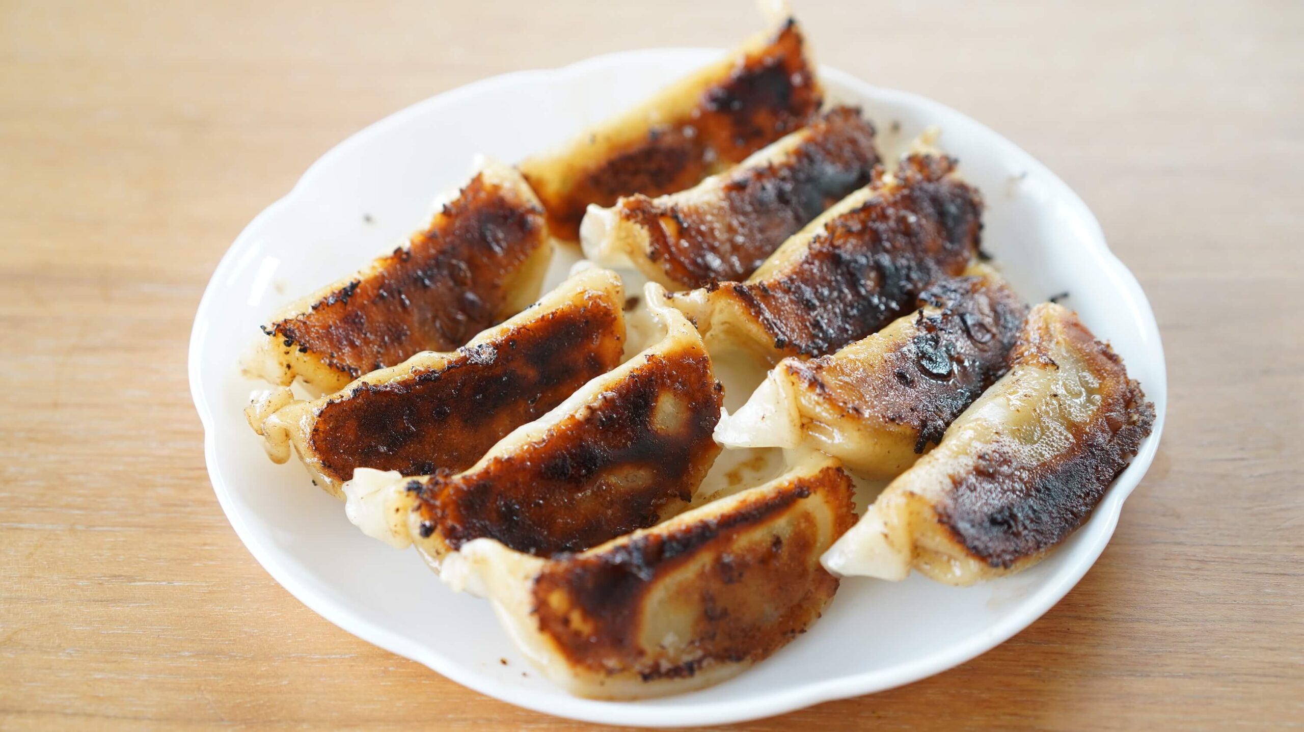 味の素の冷凍食品「黒豚肉餃子」を焼いて皿に盛りつけた写真