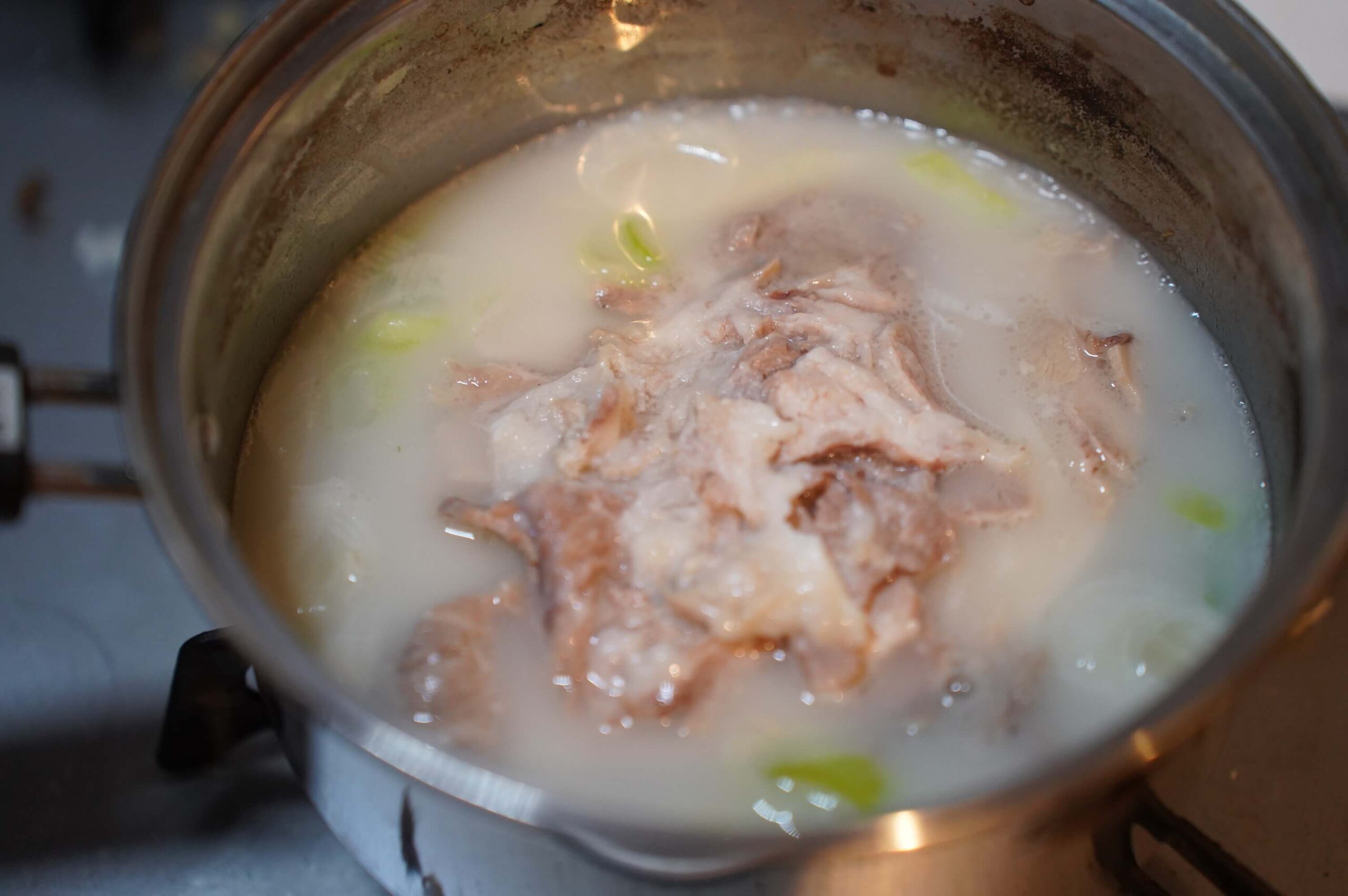 韓国料理「釜山テジクッパ」を鍋で加熱している写真